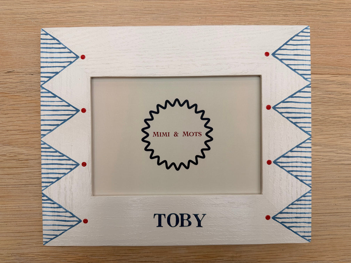 Handpainted Childs photoframe with blue and red design.  Solid oak white frame. 
