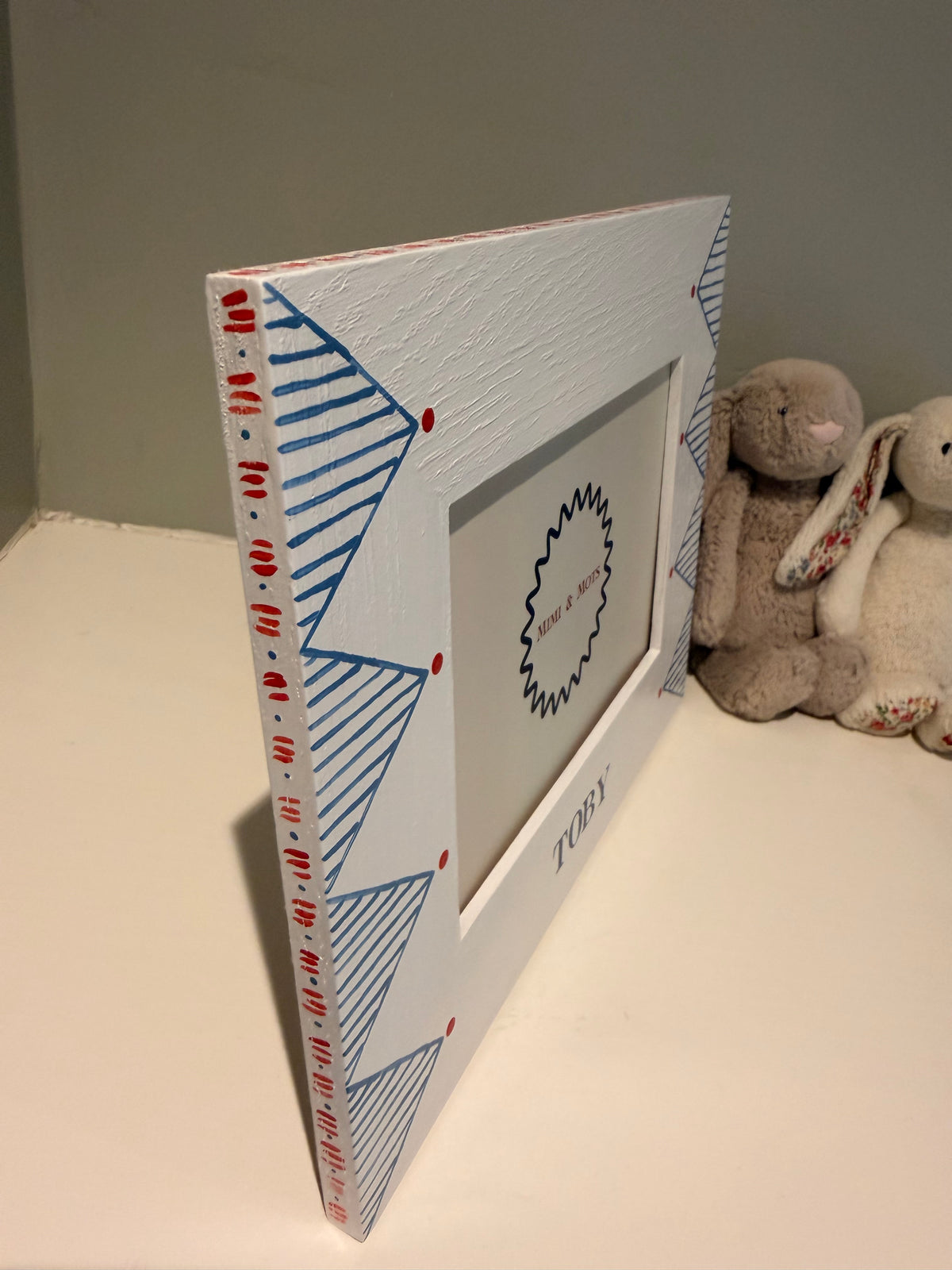 Side detail of solid oak frame with Jelly Cat bunnies. 