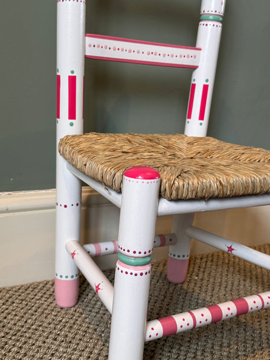 Personalised hand-painted children's chair with woven rush seat.  A unique gift for a child. Pink and Green hand-painted child's chair. 