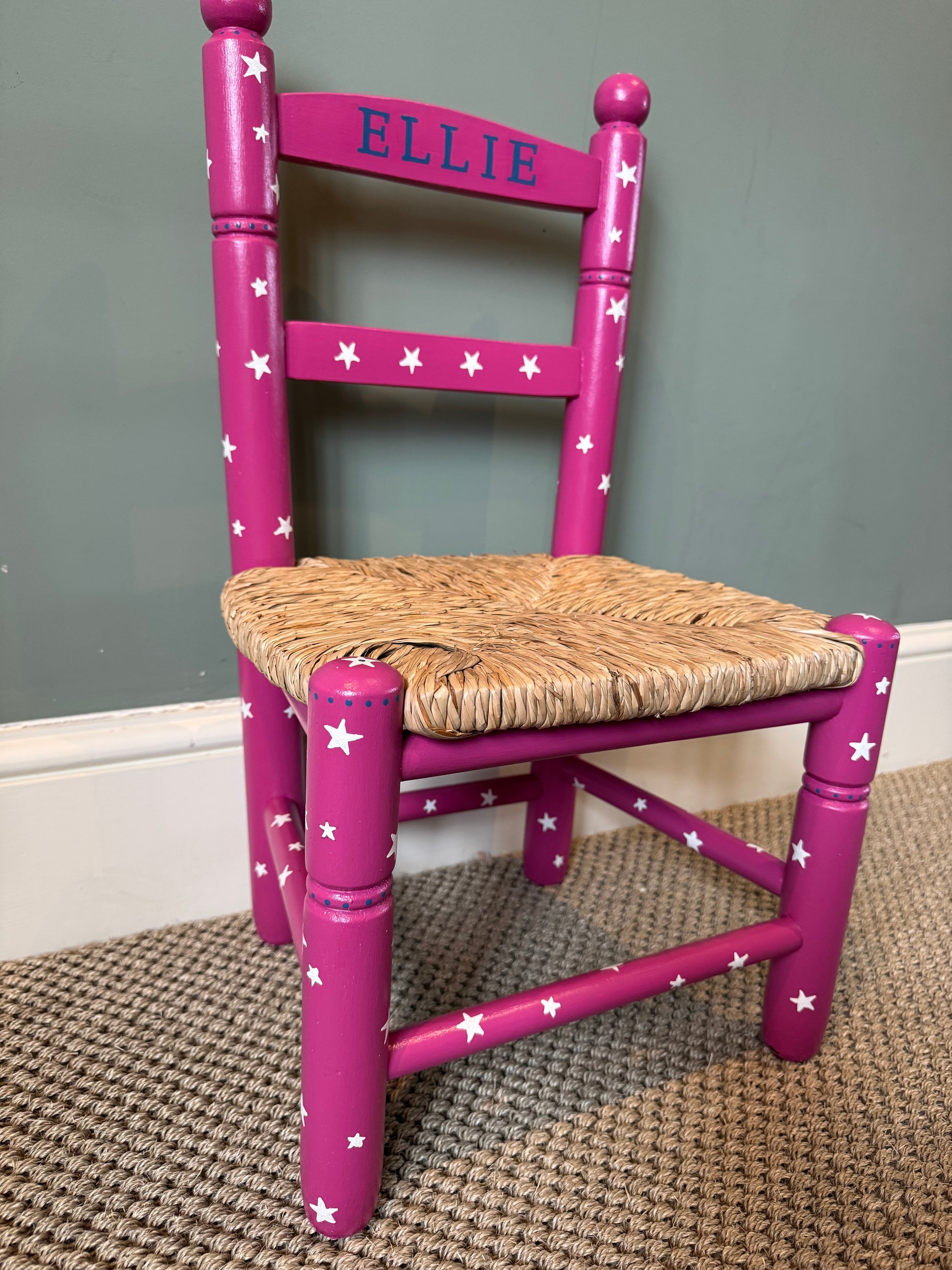 Side view of personalised dark pink children's chair with traditional woven rush seat, handmade in the UK — Mimi & Mots