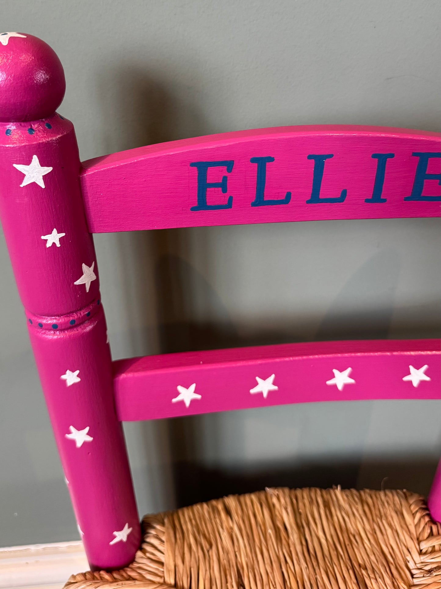 Close-up of hand-painted cream star pattern on dark pink personalised children's wooden chair — Ellie Chair by Mimi & Mots