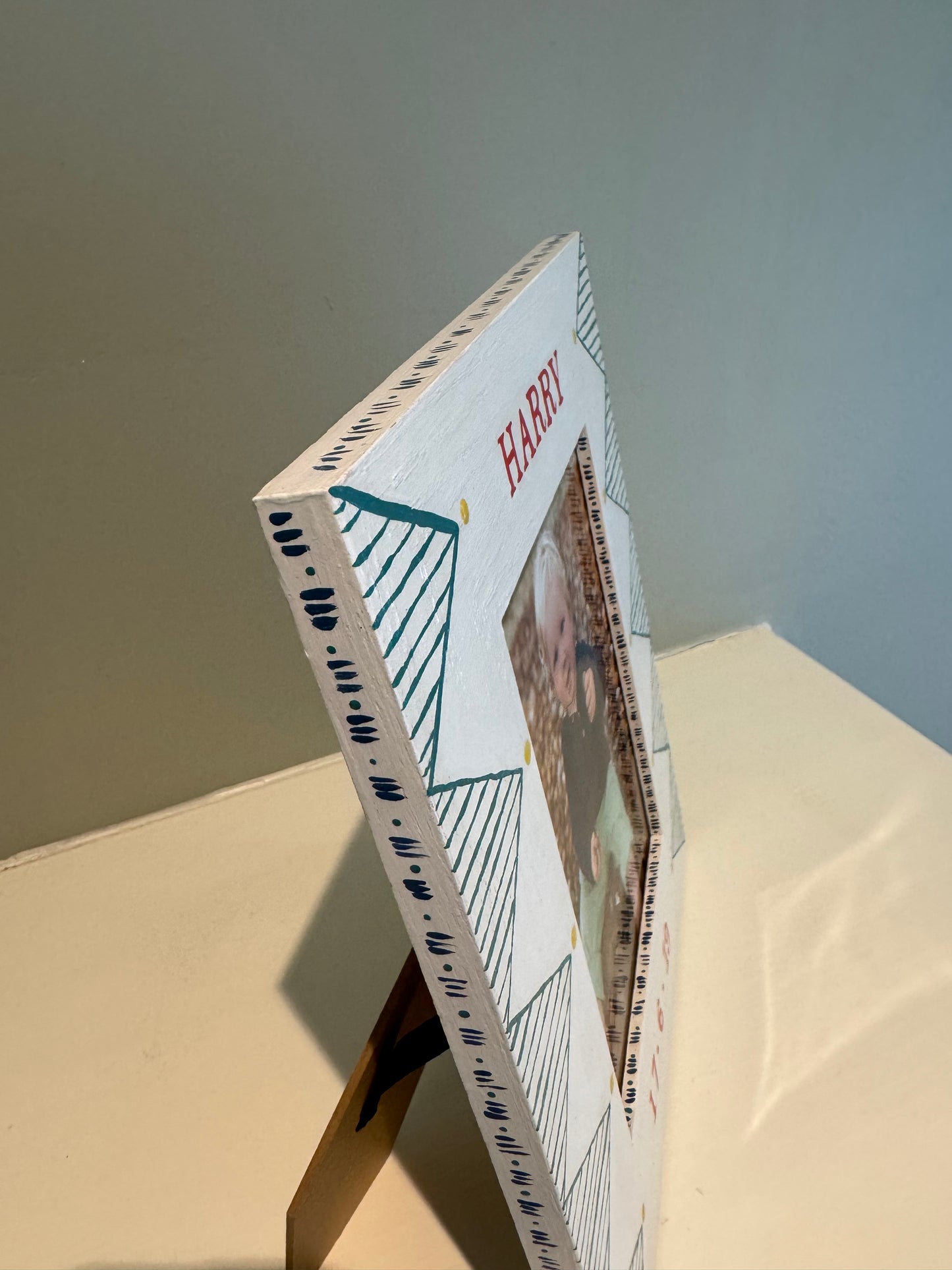 Personalised hand-painted children's photo frames in portrait orientation — green geometric and star designs by Mimi & Mots