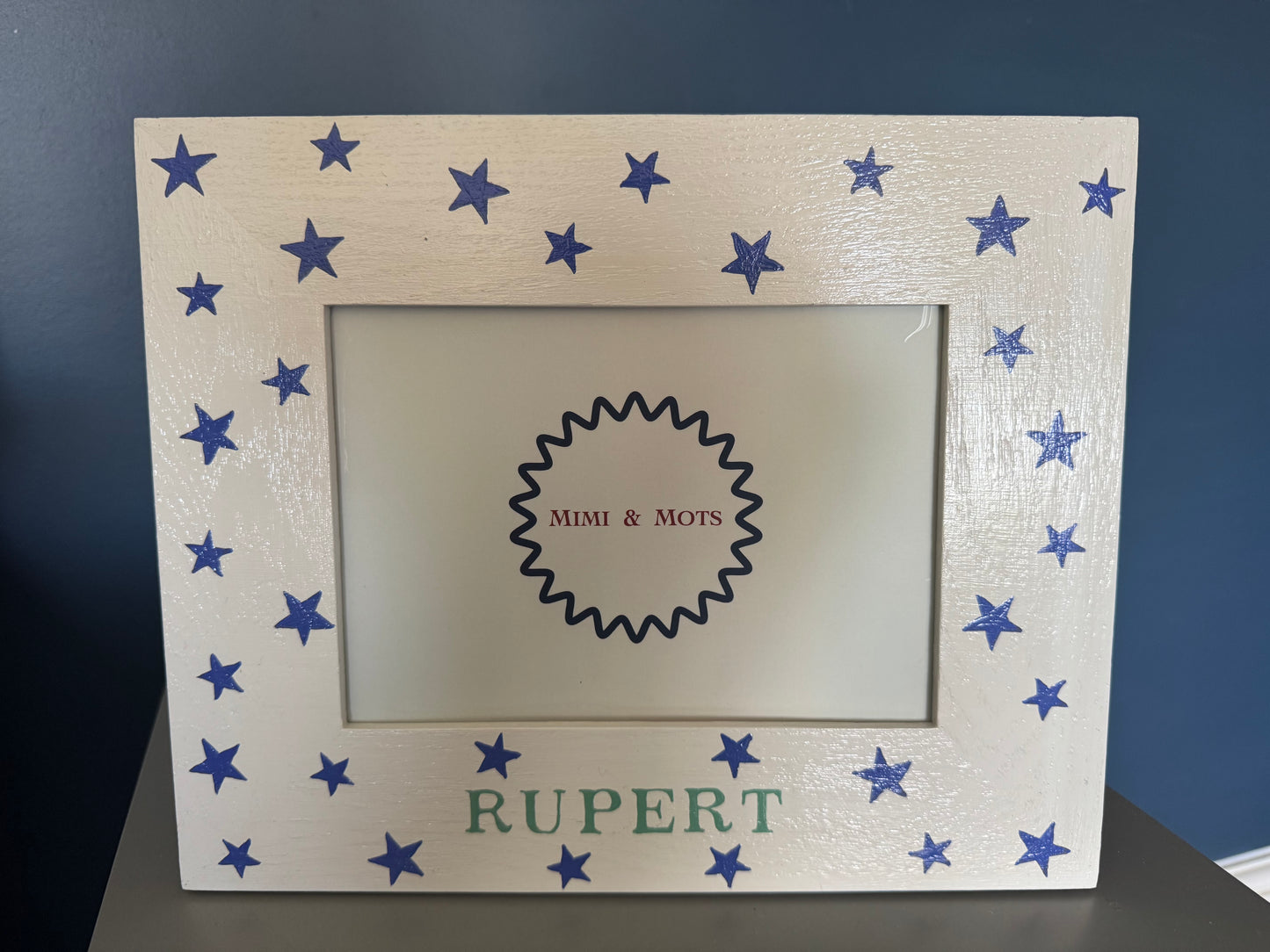 Personalised hand-painted children's photo frame with blue stars and name 'Rupert', shown with a model truck — Star Photo Frame by Mimi & Mots